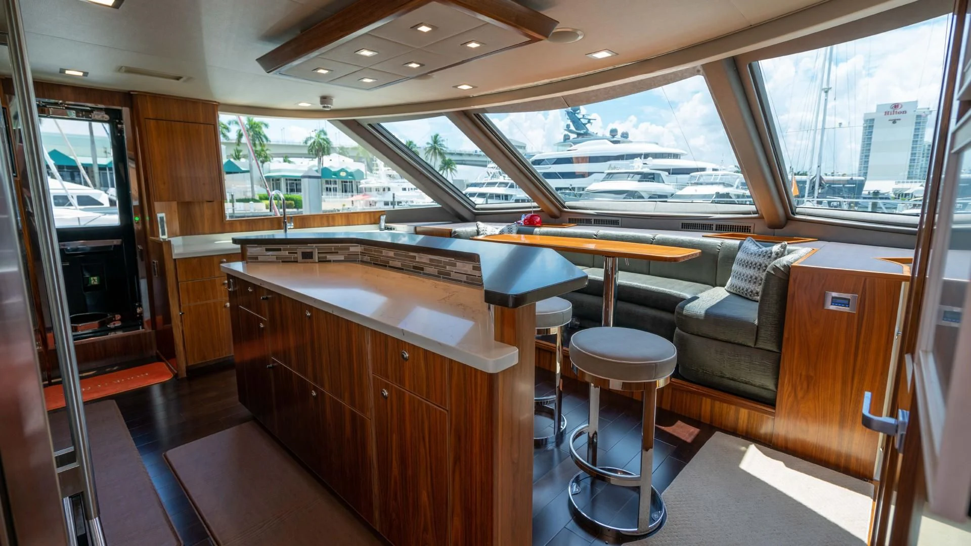 a room with a couch and a table and a window aboard OBSESSION Yacht for Sale