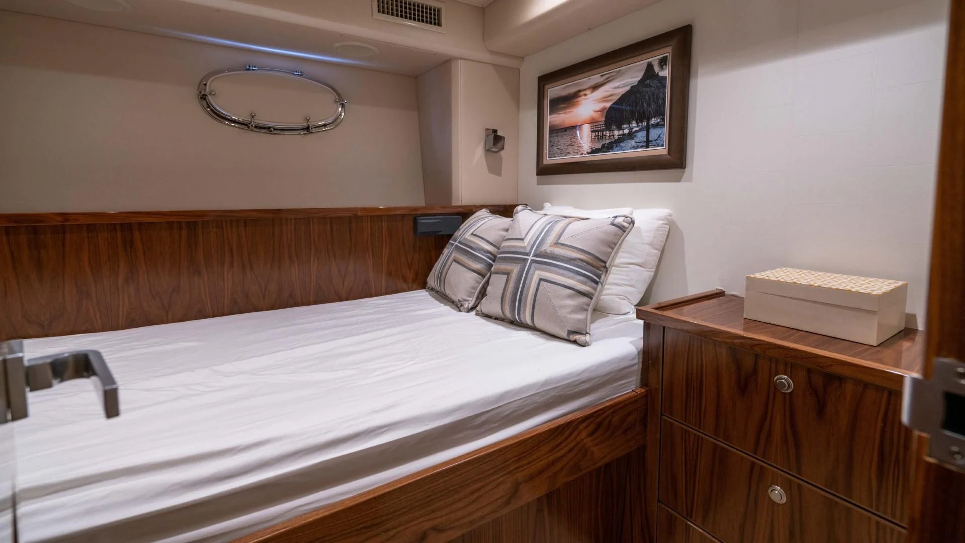 a bed with a wooden headboard aboard OBSESSION Yacht for Sale