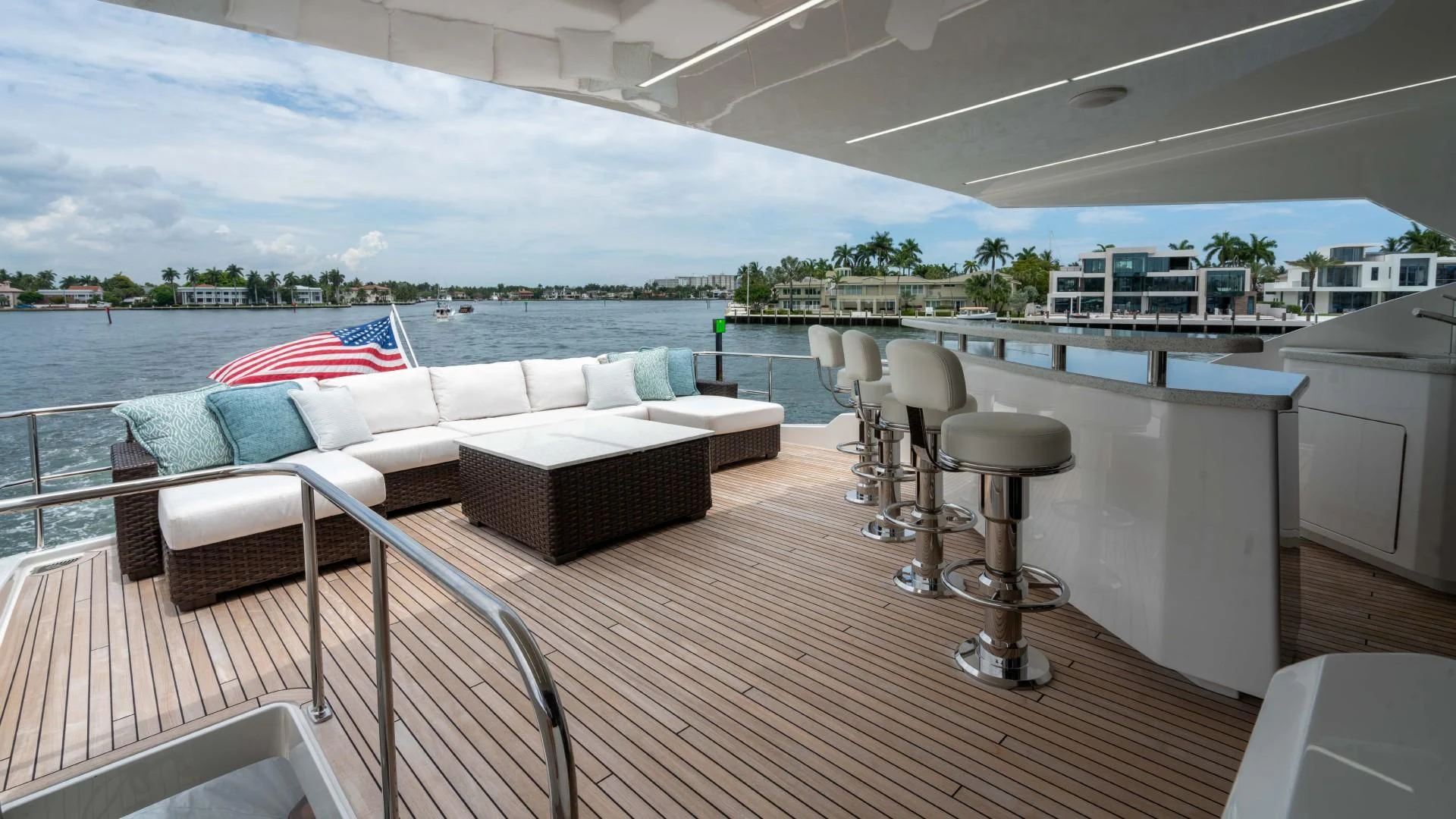 a deck with a couch and chairs aboard OBSESSION Yacht for Sale