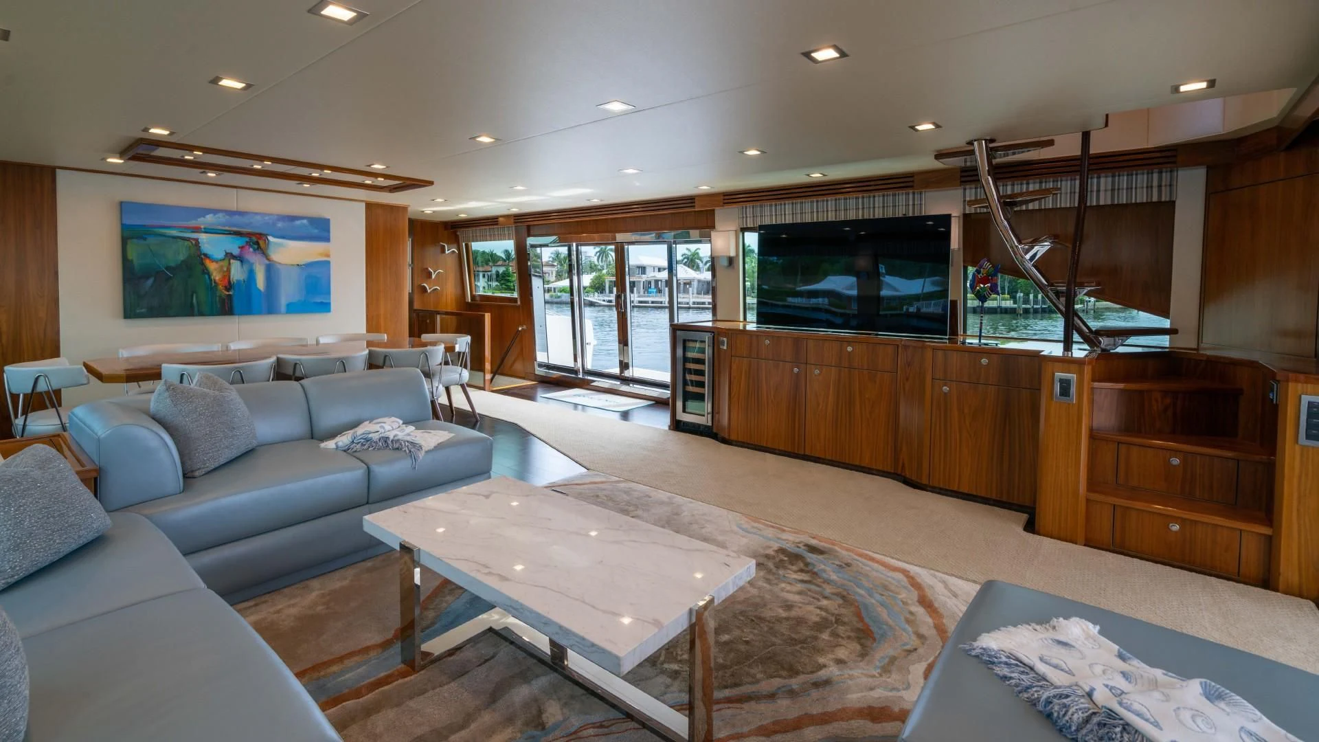 a living room with a large screen aboard OBSESSION Yacht for Sale