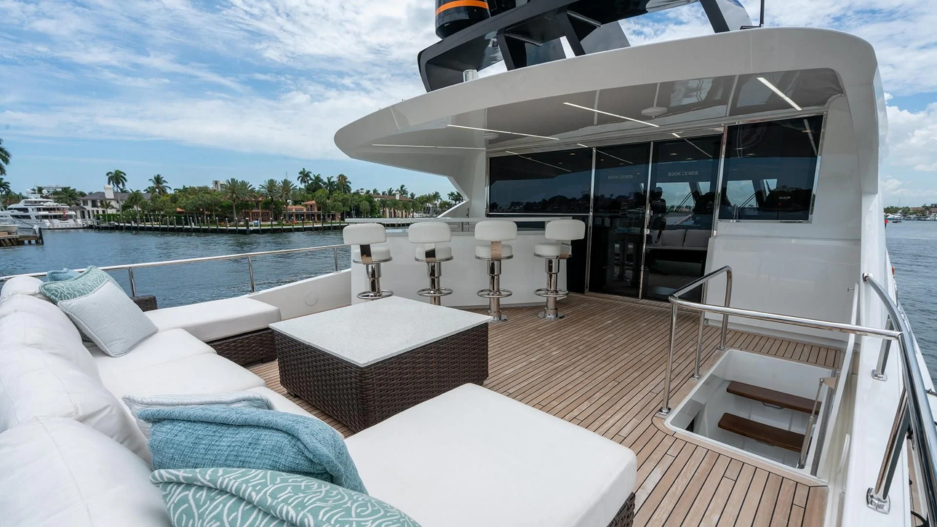 a room with a large white bed and a large white table and chairs aboard OBSESSION Yacht for Sale