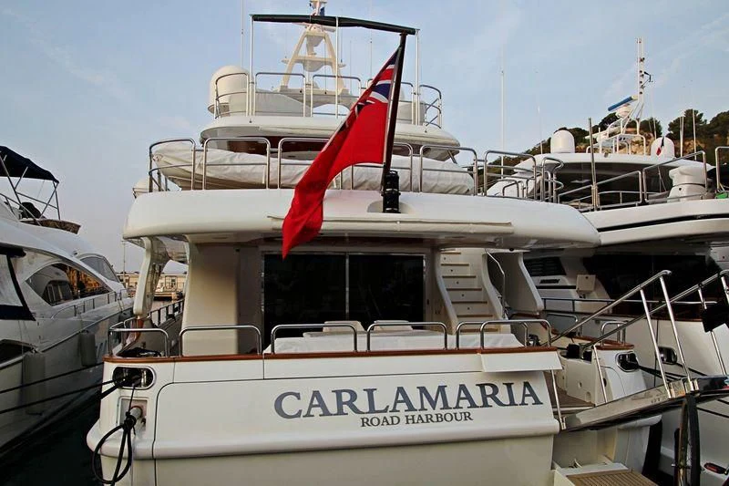 a boat with a flag on it aboard SOGNO Yacht for Sale