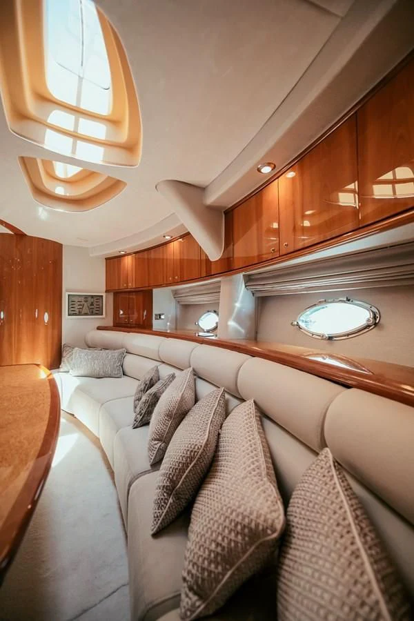 a room with a couch and a wood cabinet aboard HOURI Yacht for Sale