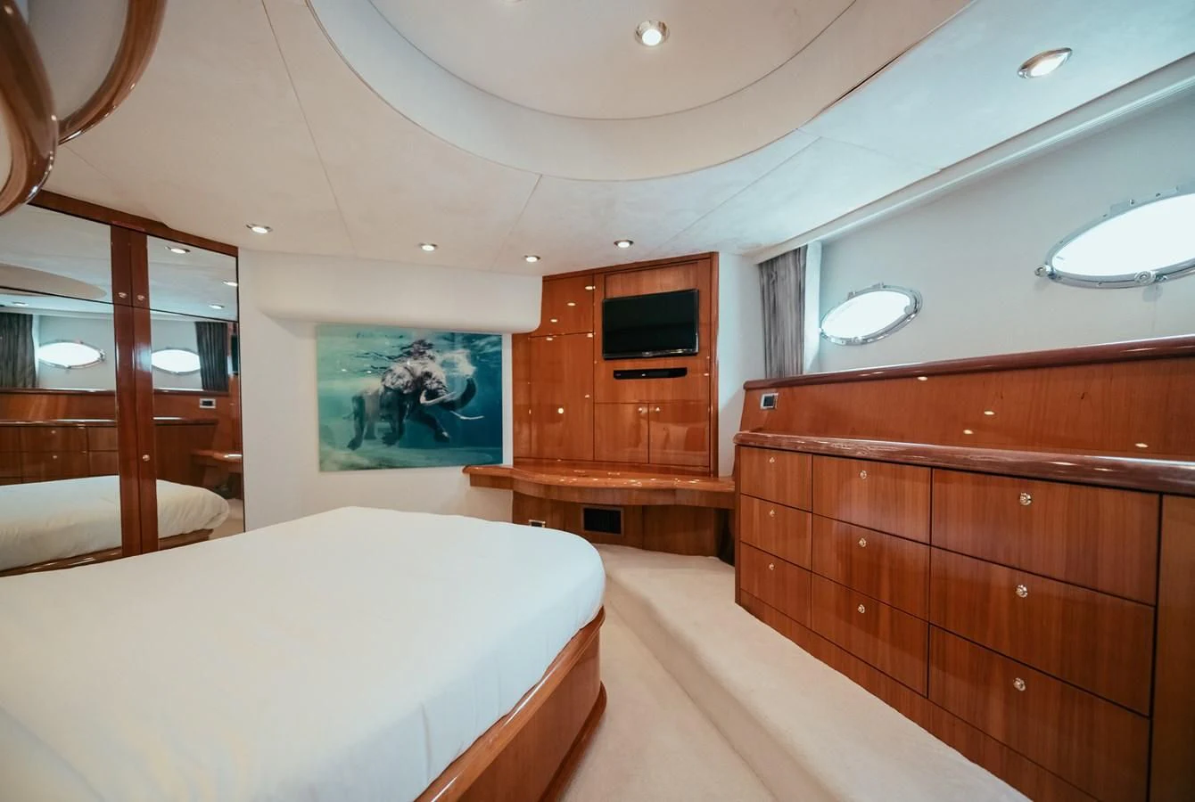 a room with a bed and a television aboard HOURI Yacht for Sale