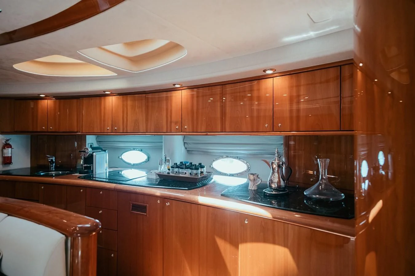 a kitchen with wooden cabinets aboard HOURI Yacht for Sale