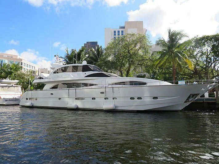 a white yacht in a harbor aboard CRAZY LOVE Yacht for Sale