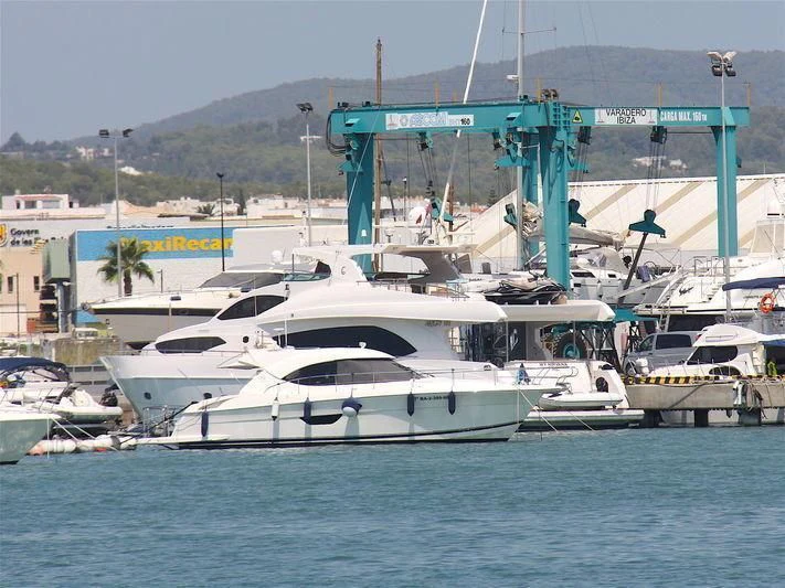 a large white boat in a harbor aboard NIRVANA Yacht for Sale