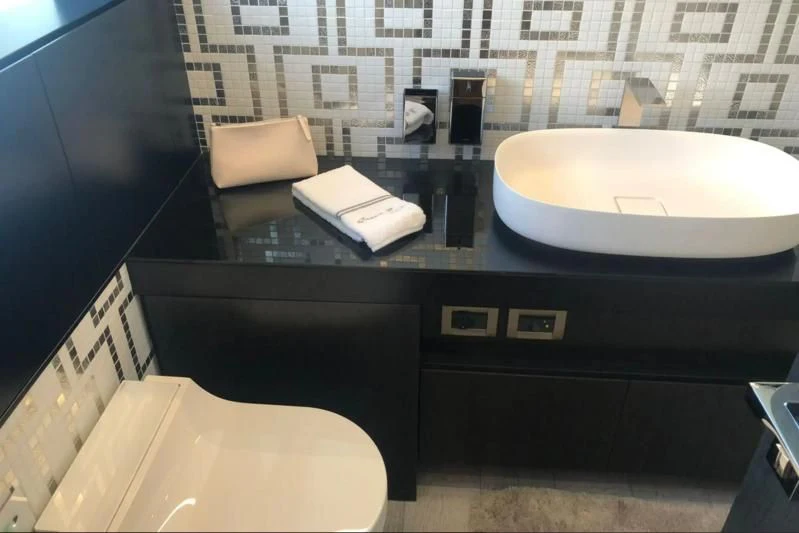 a bathroom with a sink and toilet aboard QUEEN B SPORT Yacht for Sale