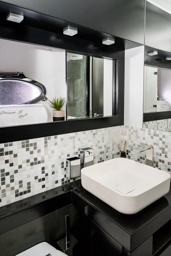 a bathroom with a large mirror aboard QUEEN B SPORT Yacht for Sale