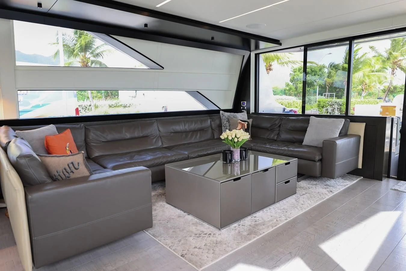 a living room with a couch and a coffee table aboard QUEEN B SPORT Yacht for Sale