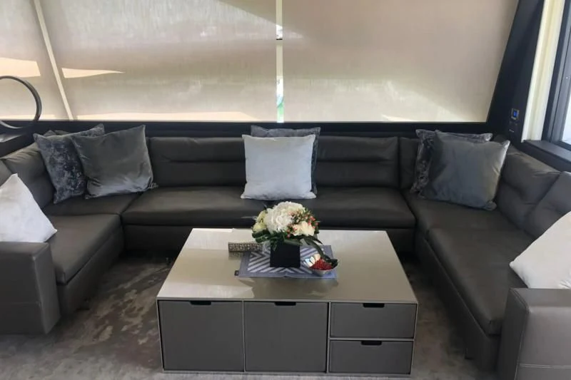 a couch with a coffee table aboard QUEEN B SPORT Yacht for Sale