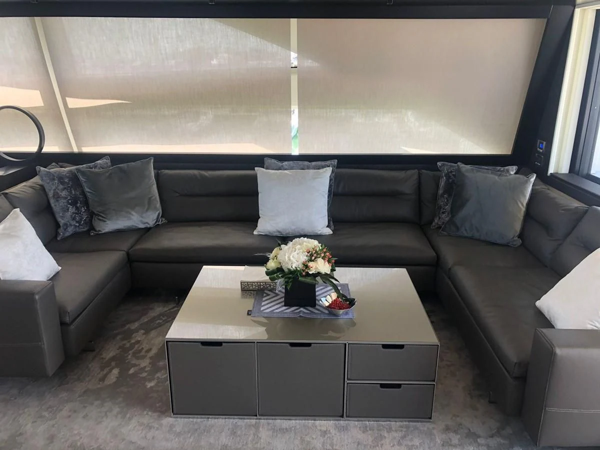 a couch with a coffee table aboard QUEEN B SPORT Yacht for Sale