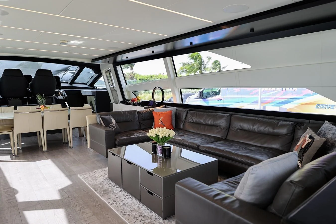 a living room with a large window aboard QUEEN B SPORT Yacht for Sale