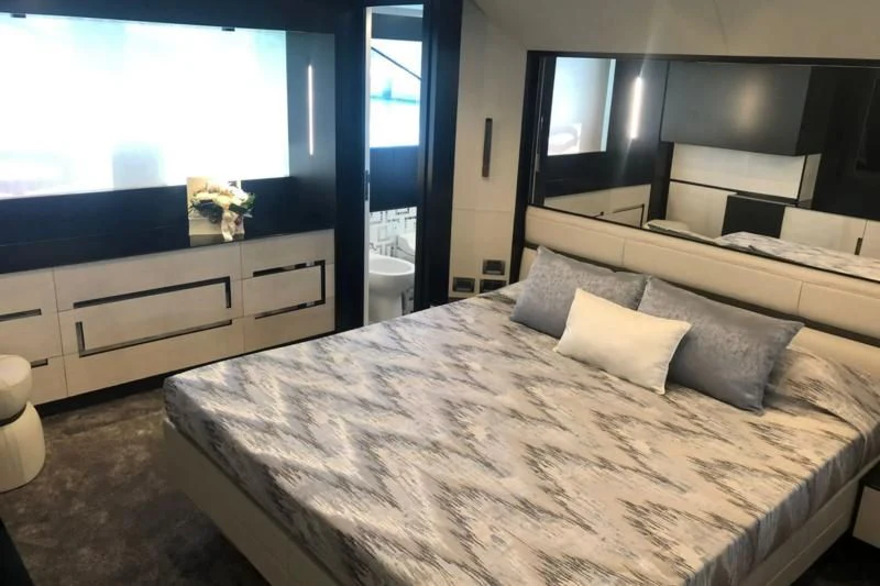 a bed with a white sheet aboard QUEEN B SPORT Yacht for Sale