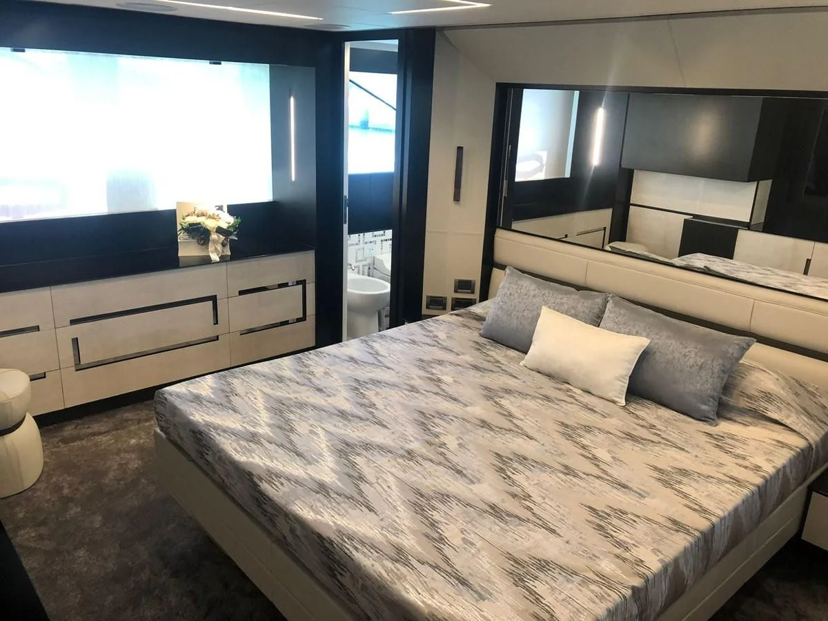 a bed with a white sheet aboard QUEEN B SPORT Yacht for Sale