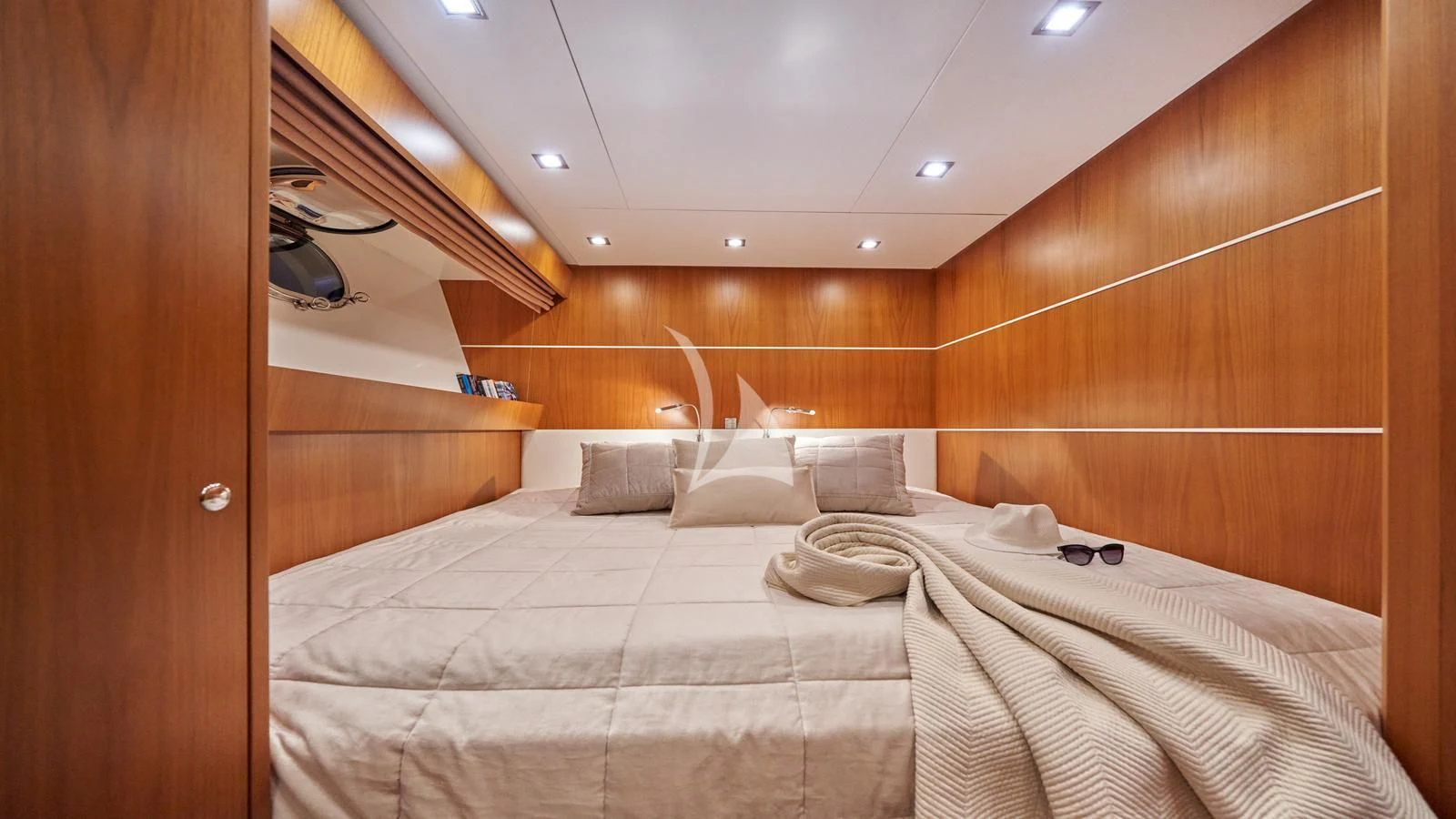 a room with a bed and a wood wall aboard KARISMA Yacht for Sale