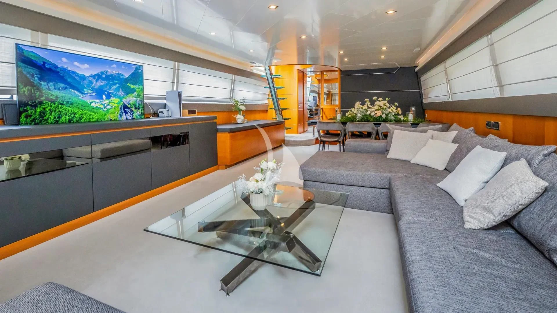 a living room with a large screen aboard KARISMA Yacht for Sale