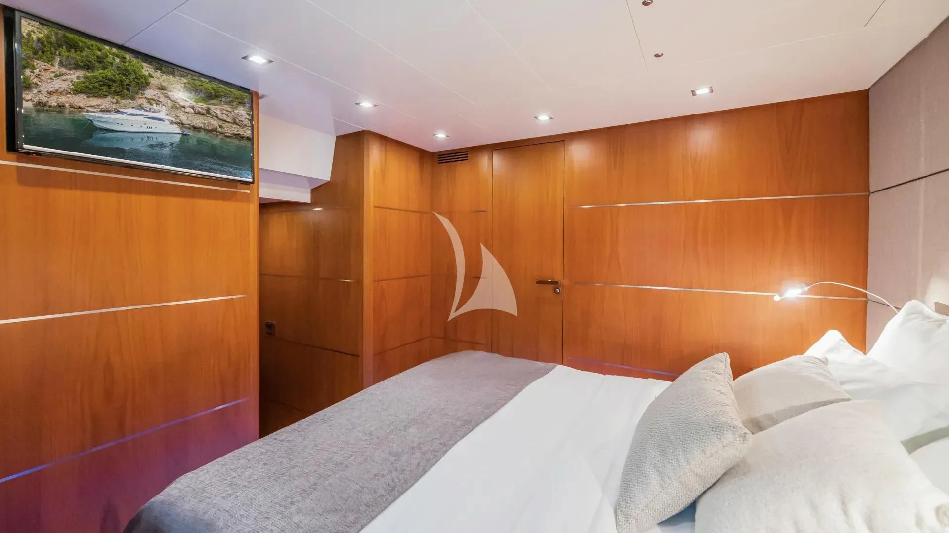 a room with a bed and a wood cabinet aboard KARISMA Yacht for Sale