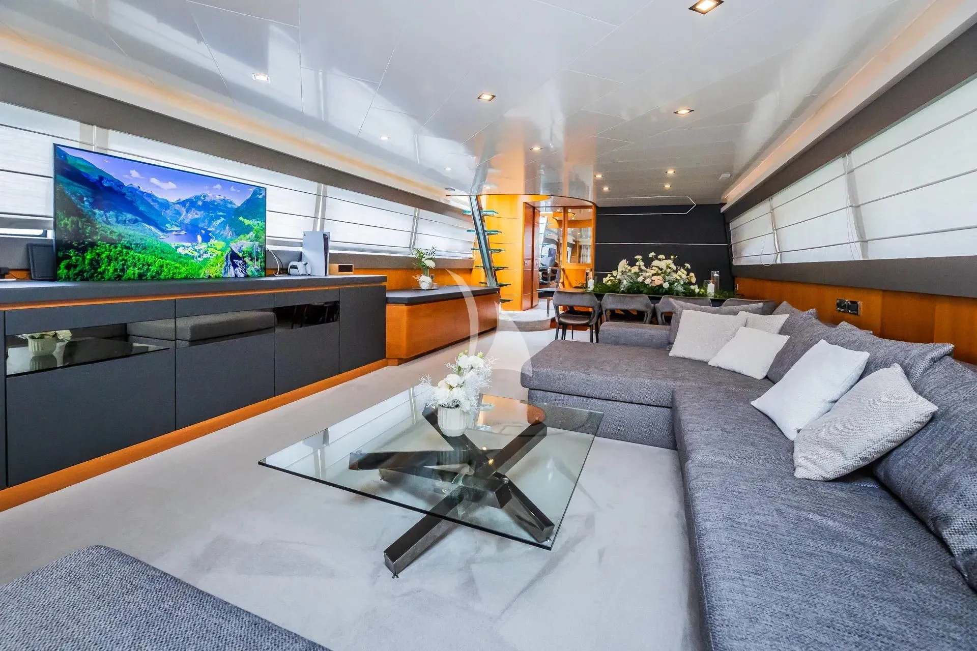 a living room with a large screen aboard KARISMA Yacht for Sale