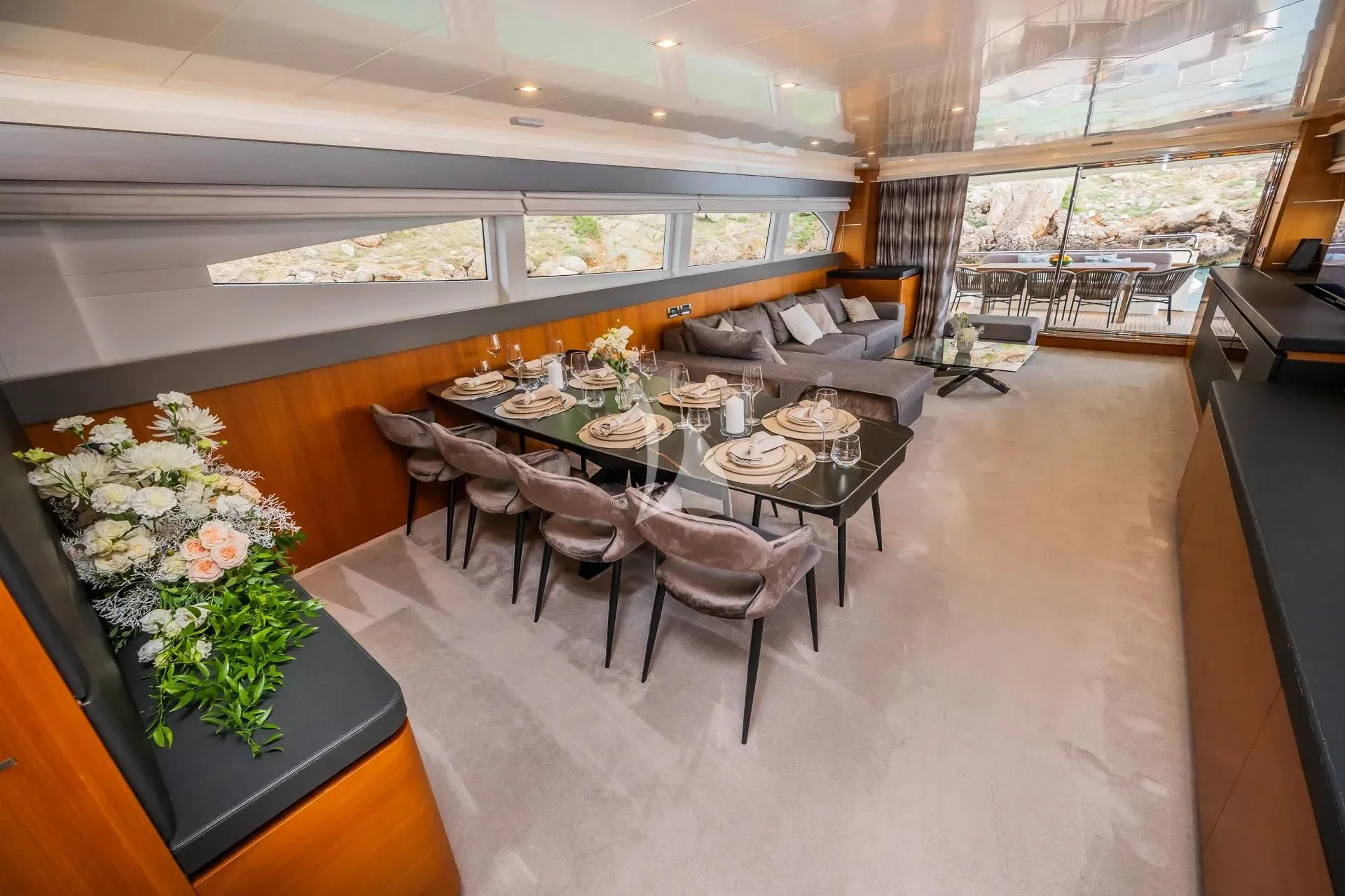 a large room with tables and chairs aboard KARISMA Yacht for Sale