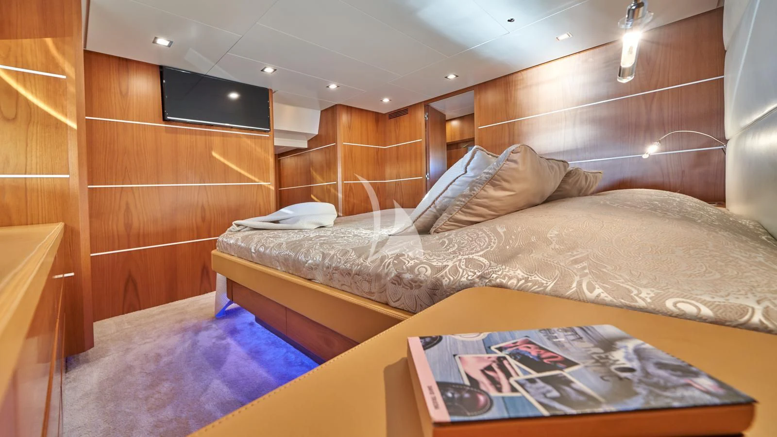 a bed with a wooden headboard aboard KARISMA Yacht for Sale