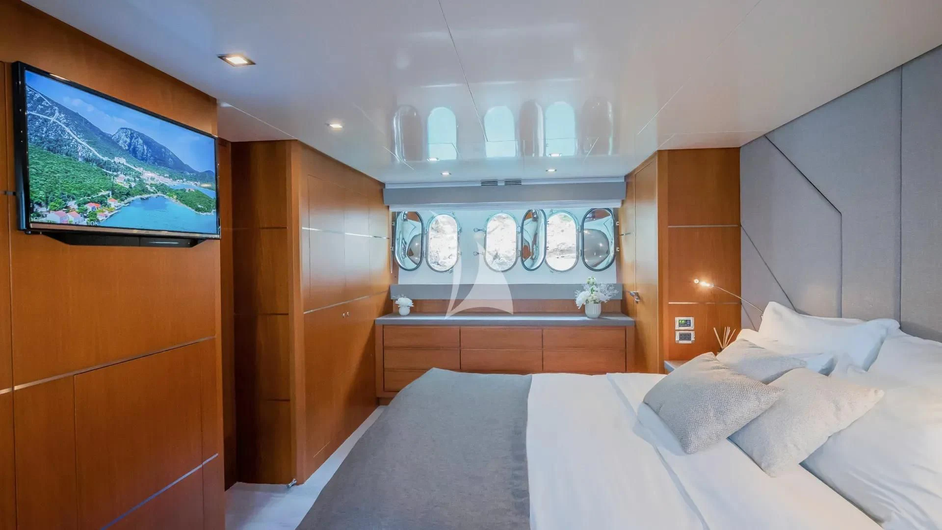 a room with a bed and cabinets aboard KARISMA Yacht for Sale