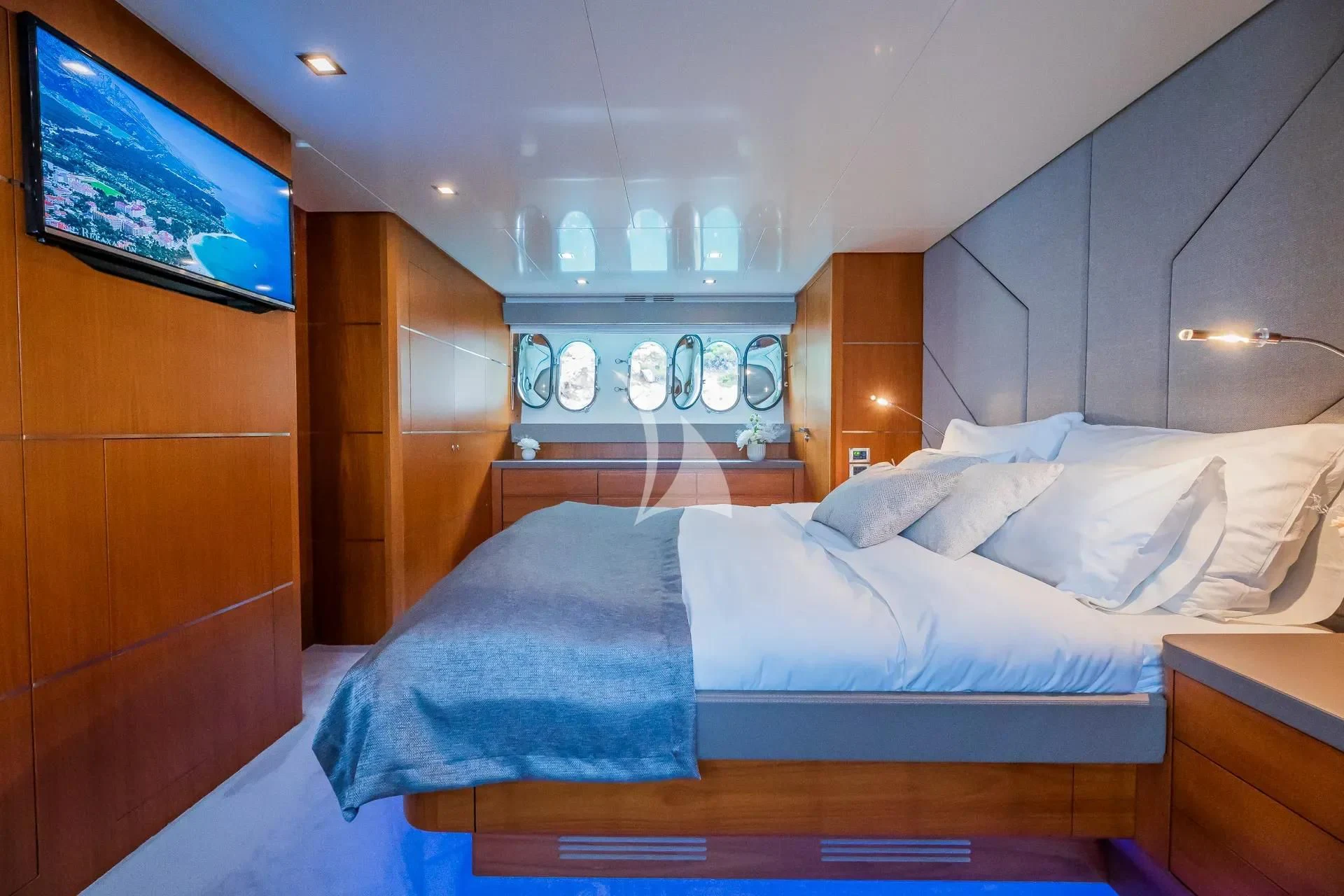 a room with a bed and a wood cabinet aboard KARISMA Yacht for Sale