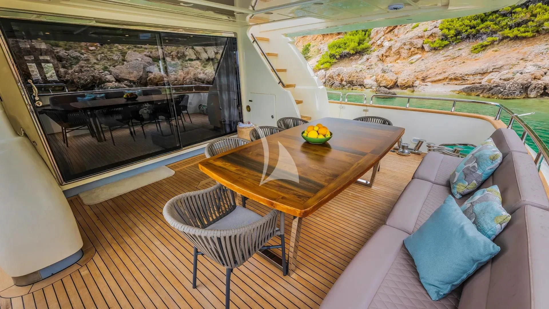 a table and chairs on a deck aboard KARISMA Yacht for Sale