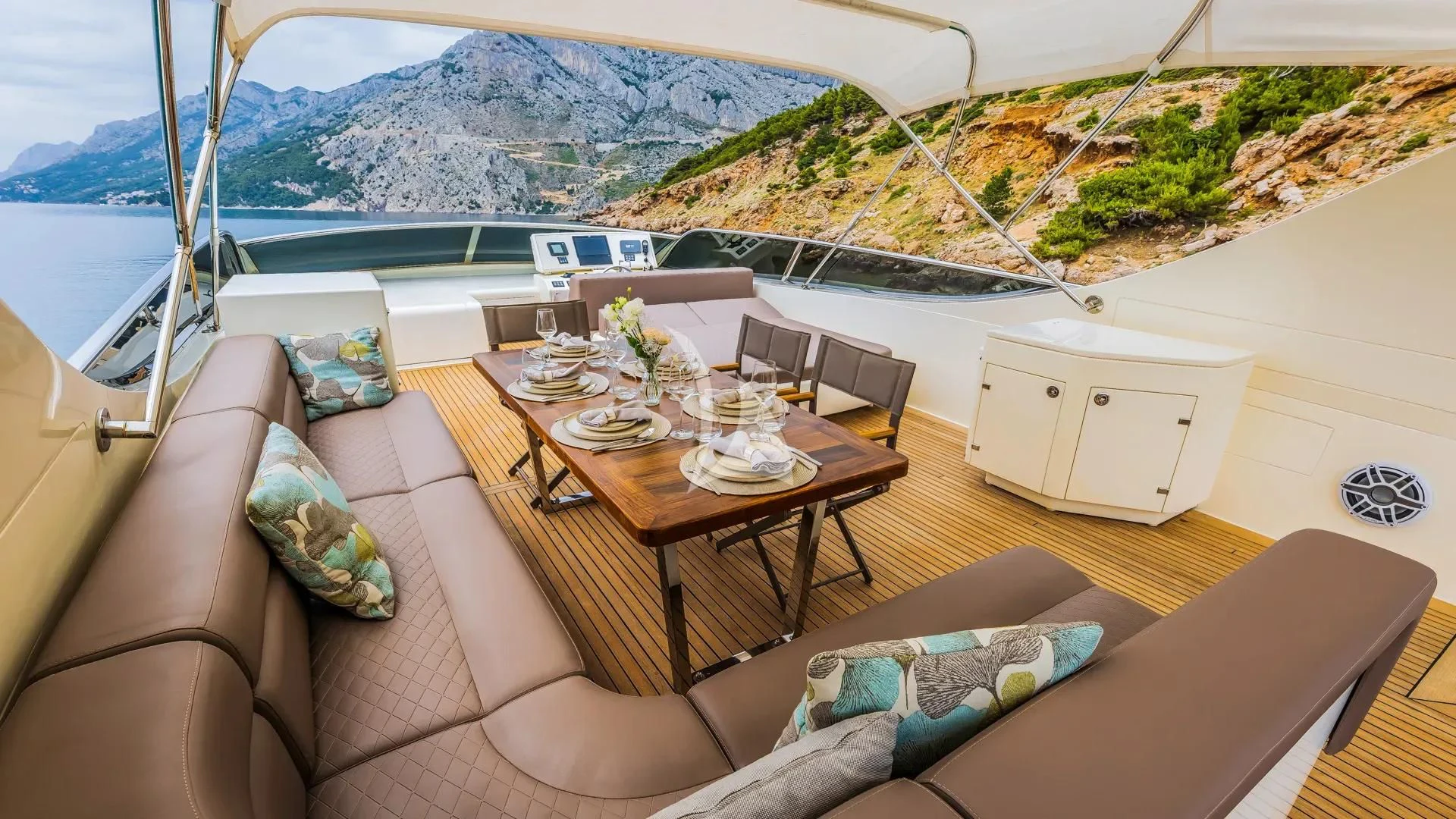 a room with a bed and a table and chairs aboard KARISMA Yacht for Sale