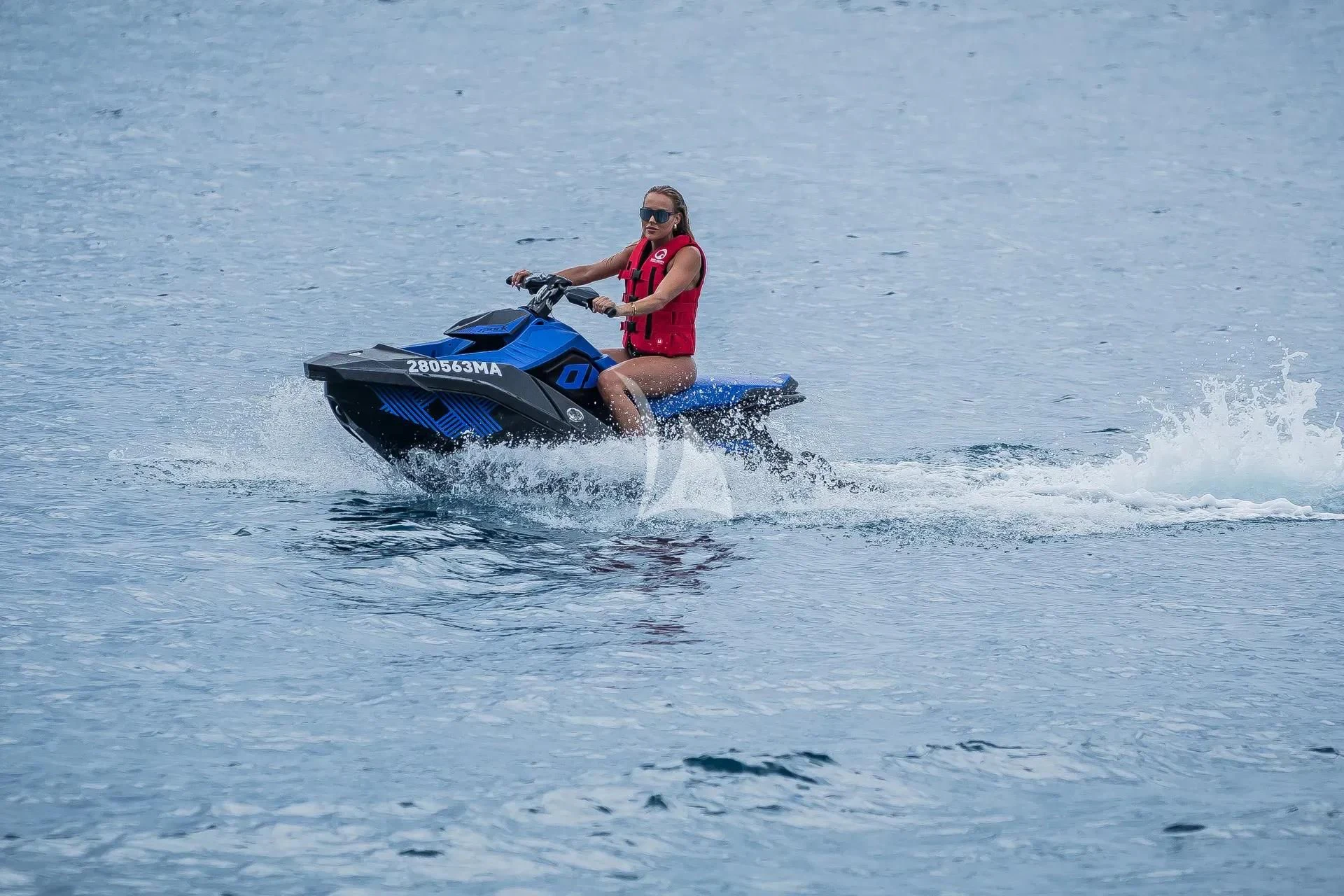 a man riding a jet ski aboard KARISMA Yacht for Sale