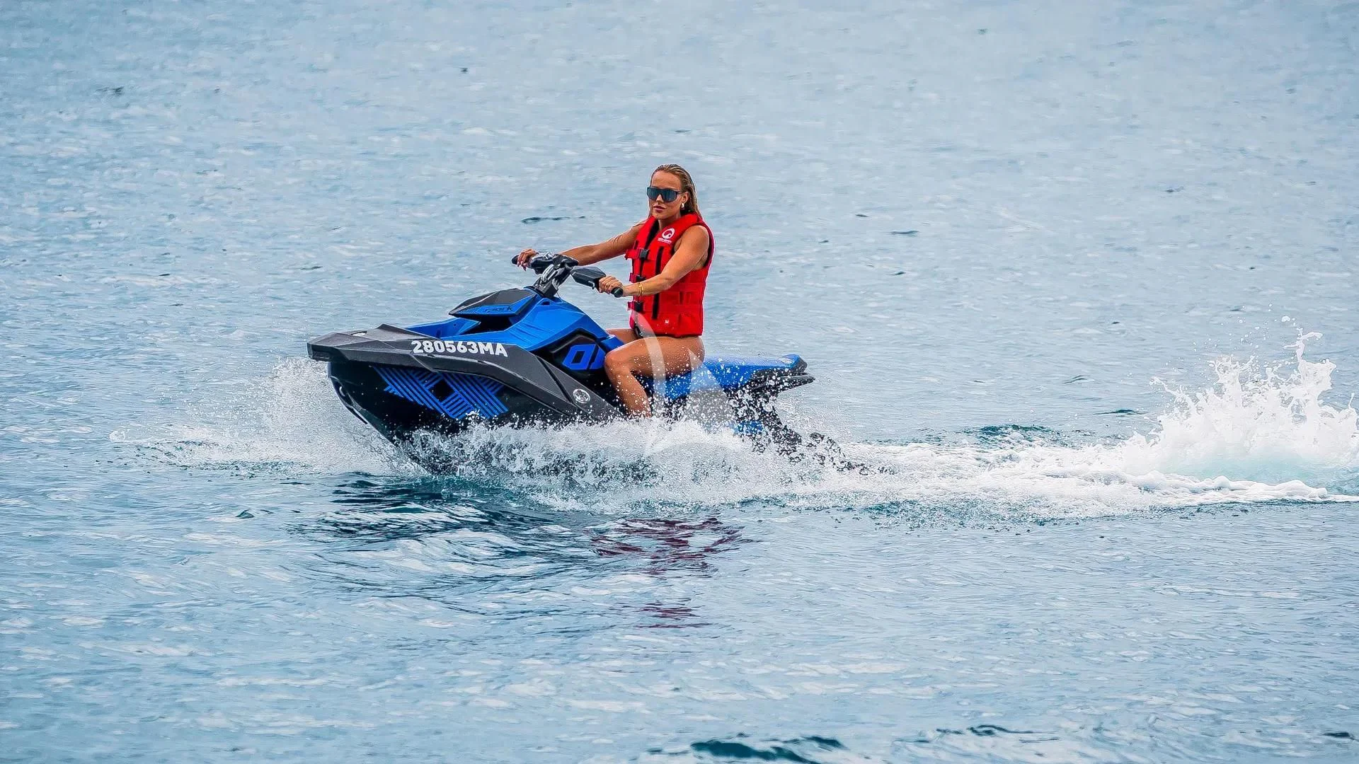 a man riding a jet ski aboard KARISMA Yacht for Sale
