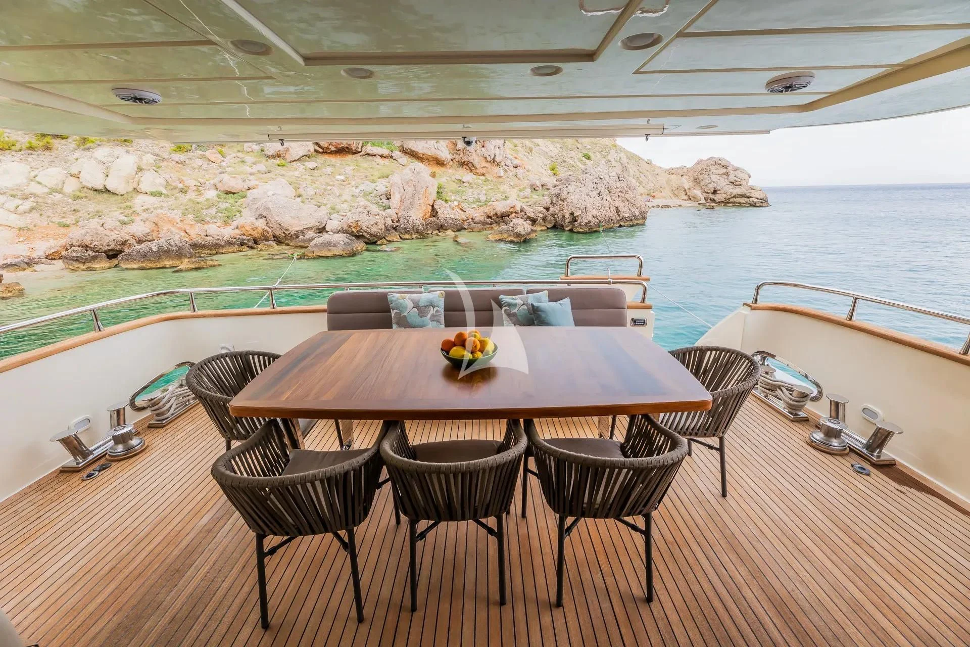 a table on a deck overlooking the ocean aboard KARISMA Yacht for Sale