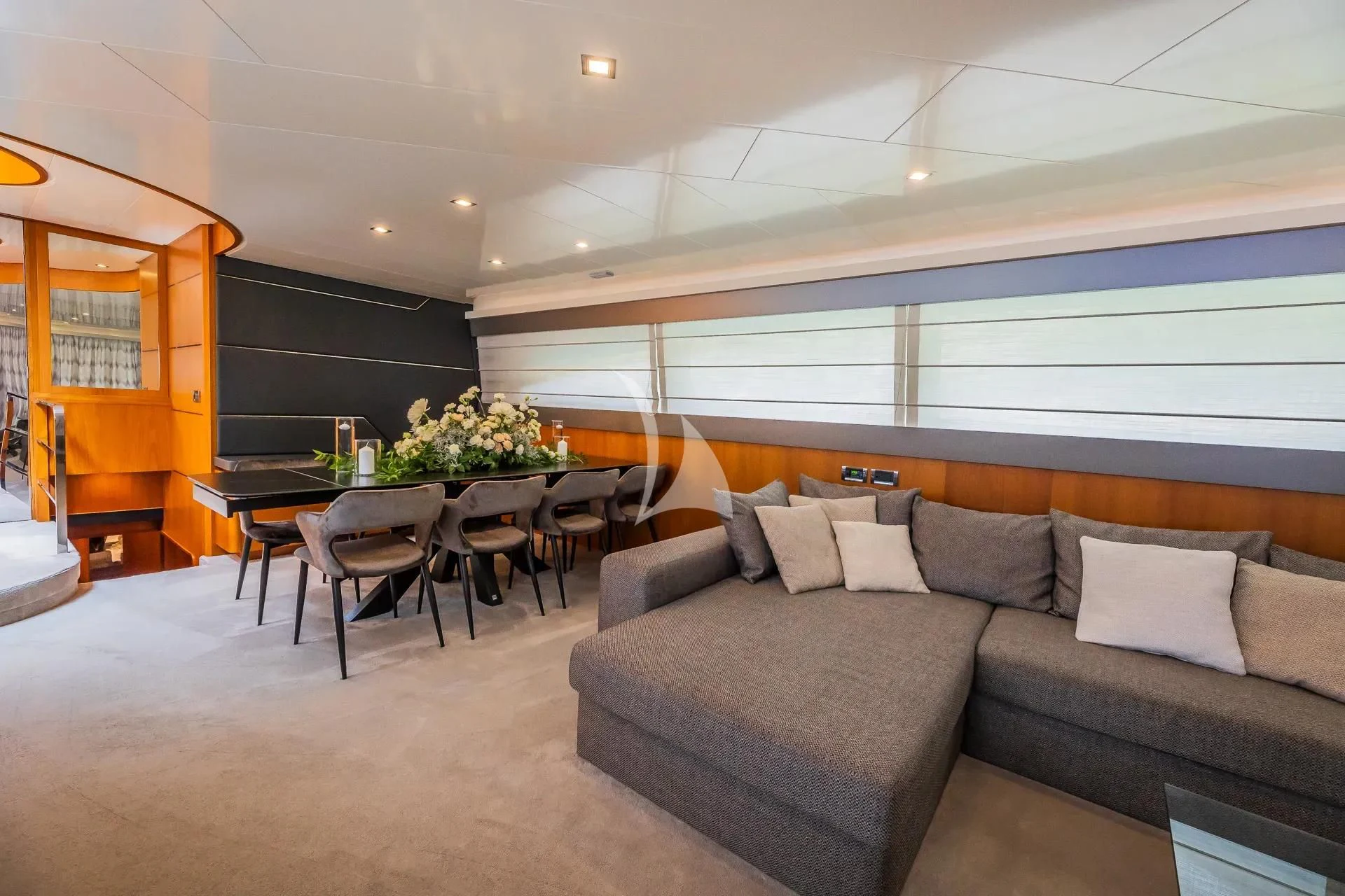 a living room with a couch and a table aboard KARISMA Yacht for Sale