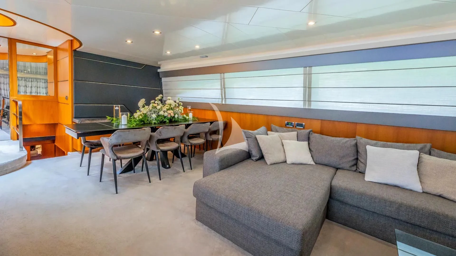 a living room with a couch and a table aboard KARISMA Yacht for Sale