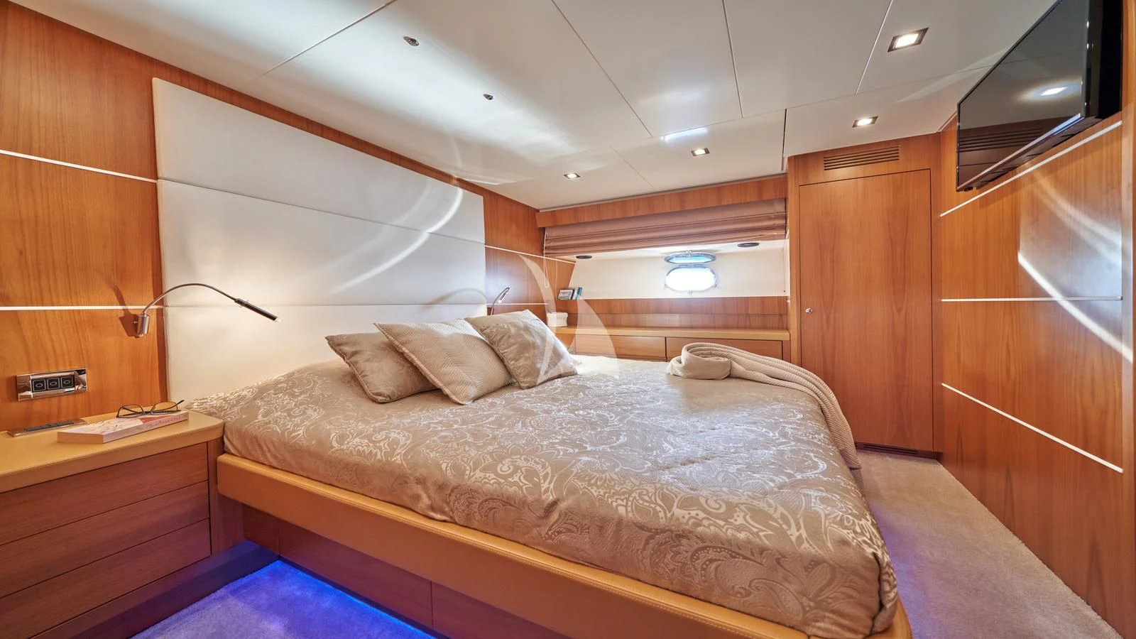 a room with a bed and a wood cabinet aboard KARISMA Yacht for Sale