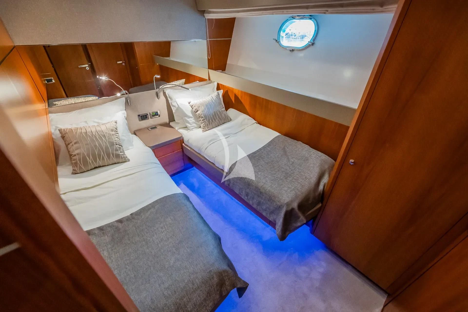 a room with beds and a mirror aboard KARISMA Yacht for Sale