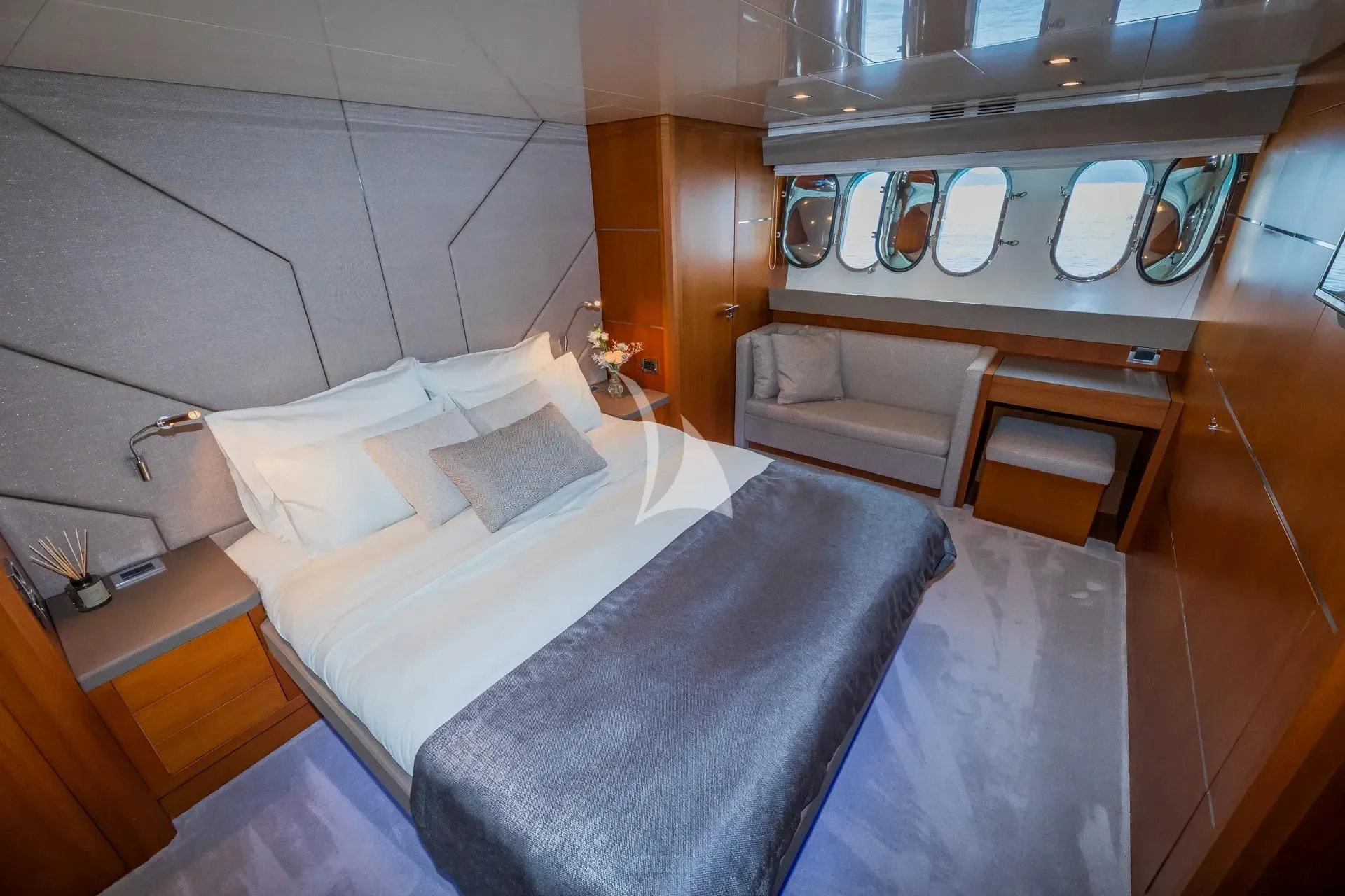 a room with a bed and a chair aboard KARISMA Yacht for Sale