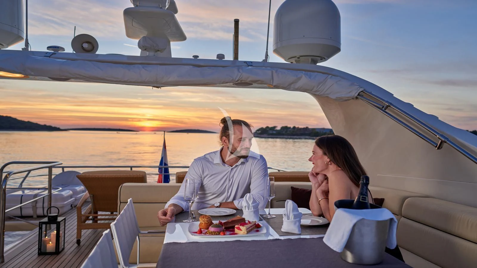 a couple sitting at a table with food on it aboard KARISMA Yacht for Sale