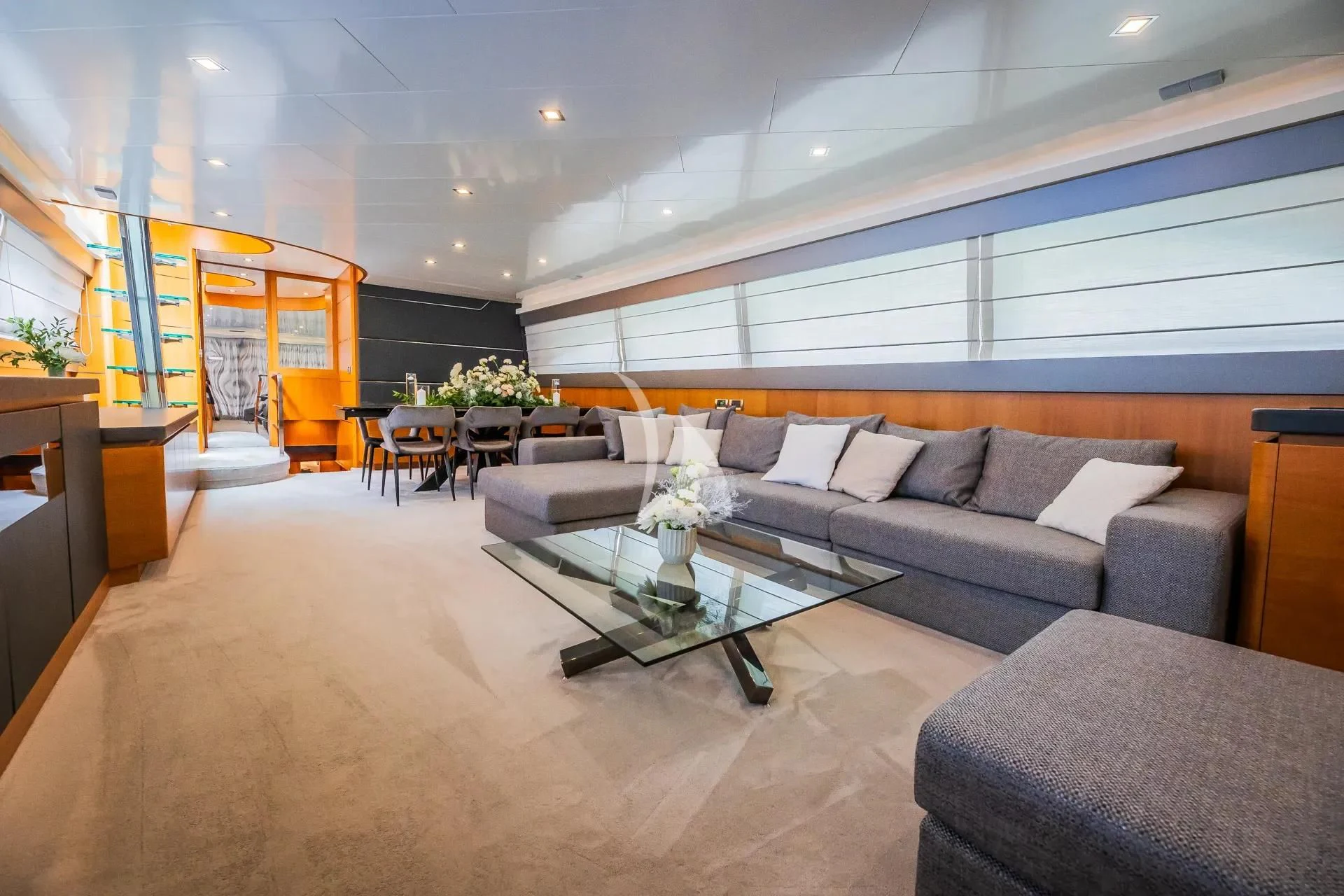 a living room with a couch and a coffee table aboard KARISMA Yacht for Sale