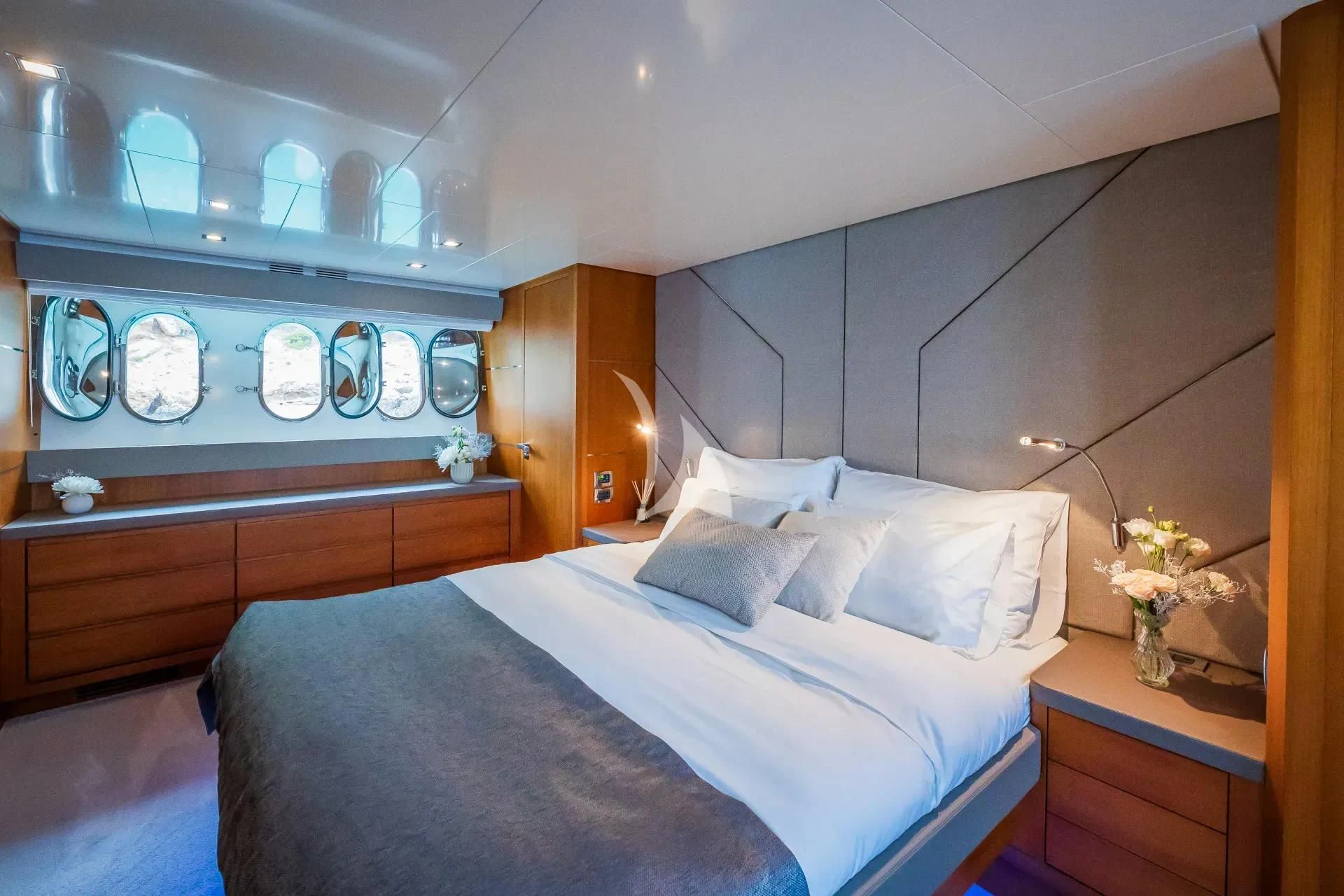a bedroom with a bed and cabinets aboard KARISMA Yacht for Sale