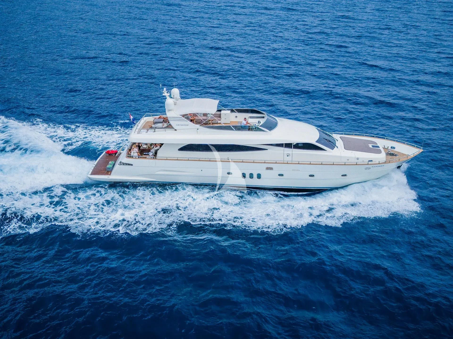 a white yacht in the ocean aboard KARISMA Yacht for Sale