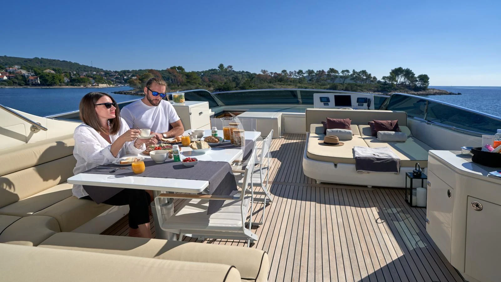 a couple sitting at a table on a boat aboard KARISMA Yacht for Sale