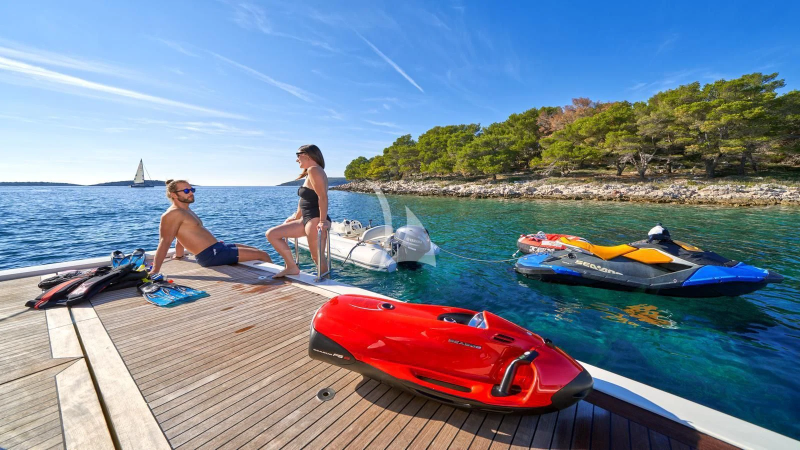 a couple of people sitting on a dock next to kayaks aboard KARISMA Yacht for Sale