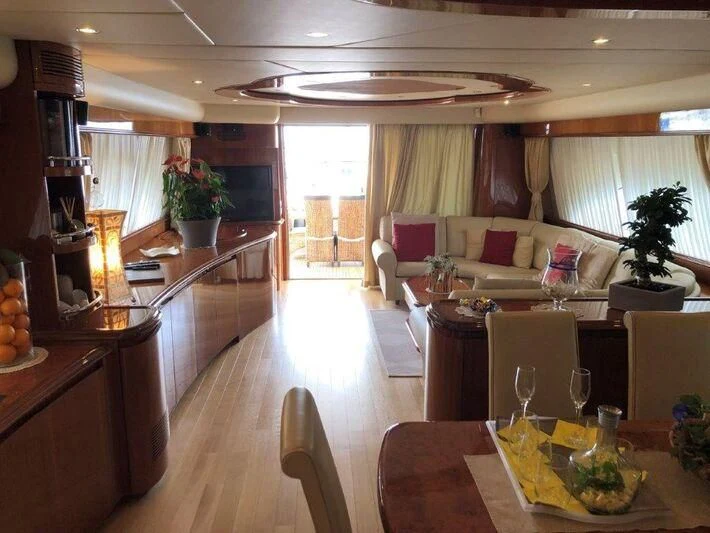 a living room with a table and chairs aboard JAUNI Yacht for Sale