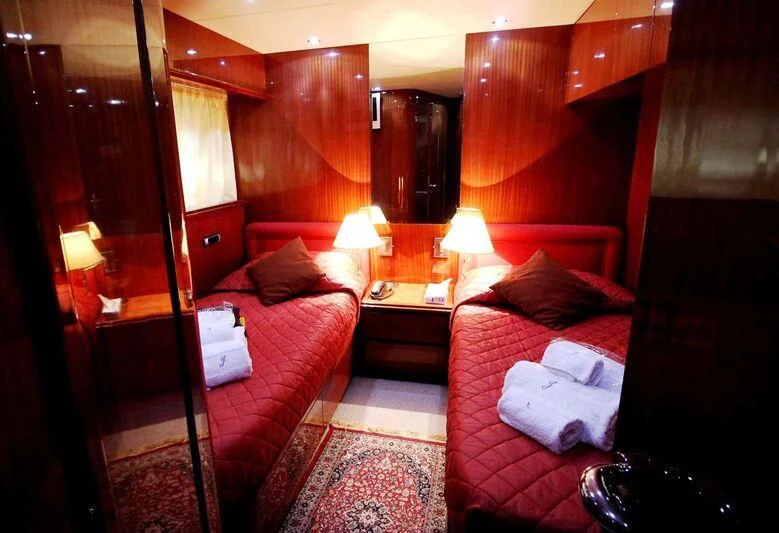 a room with a bed and a desk aboard JAUNI Yacht for Sale