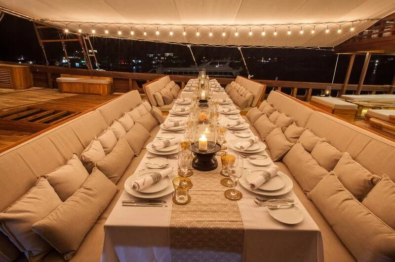 a large room with a table and chairs aboard PRANA Yacht for Charter
