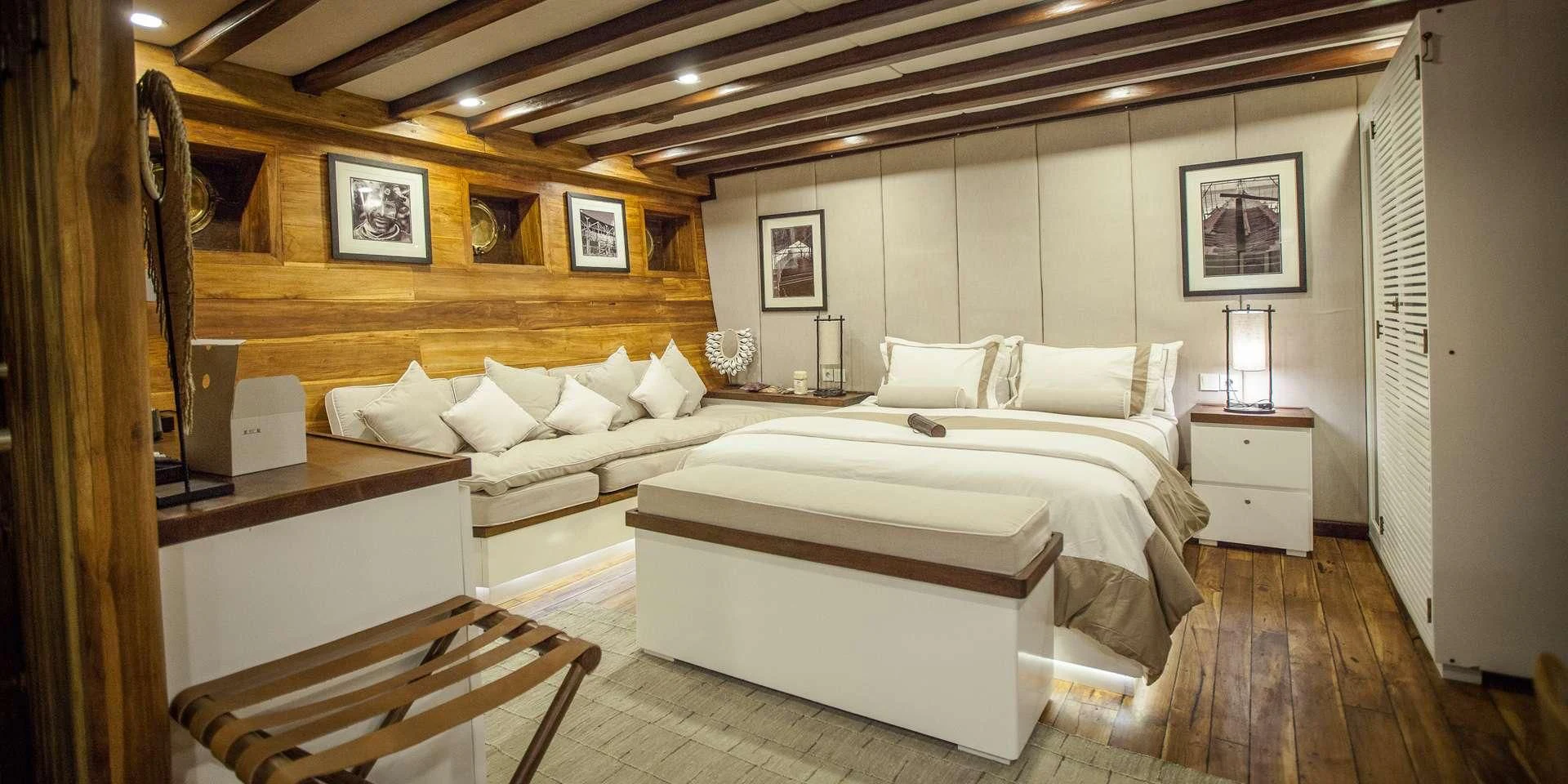 a room with a bed and a desk aboard PRANA Yacht for Charter