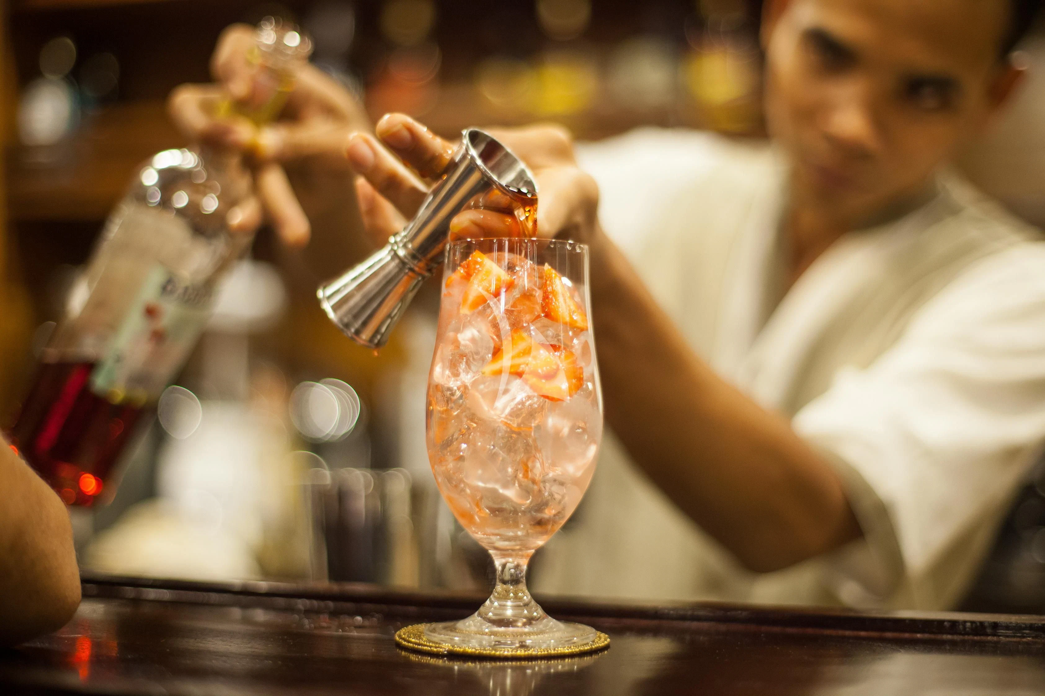 a person pouring a glass of beer aboard PRANA Yacht for Charter