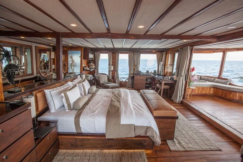 a large bedroom with a large bed aboard PRANA Yacht for Charter