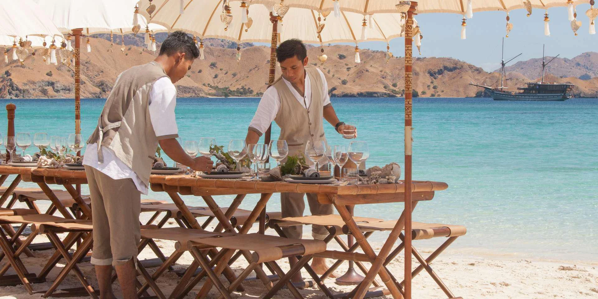 two men standing at a table aboard PRANA Yacht for Charter